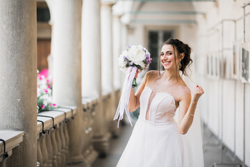 Naklejka premium Bride holding big and beautiful wedding bouquet with flowers