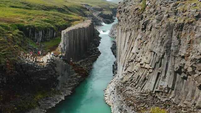 Aerial footage of Studlagil volcanic basalt Canyon, Jokulsa Bru river Highlands of Iceland Popular tourist attraction.