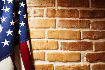 USA flag near a brick wall. Texture background image