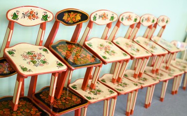 Khokhloma painted chairs stand in a row