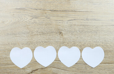 Fototapeta na wymiar Empty white paper heart shape on wooden floor.