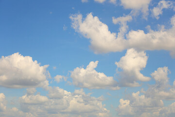 Blue sky with white clouds in the daytime background.