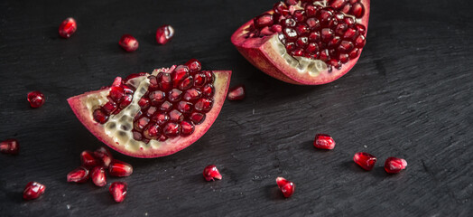Fresh Pomegranate in black texture background