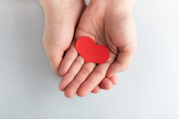 Greeting card for Valentine's Day. Heart is in hands.