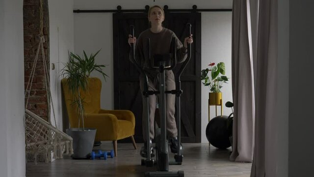 woman is doing workout in the orbitrack at home