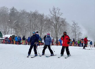 Line of people to ski lift wearing masks due Covid-19 regulations at Stowe Mountain Resort, VT