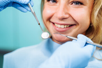 Close-up of the dentist's hands with medical devices. Large detail - dentist's mirror, curling and probe. Resolving dental problems effectively with confident, professional gestures