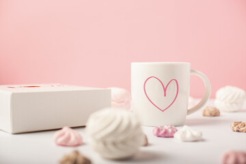 Festive composition for Valentine's Day. Mug and sweets on a pink background. Banner