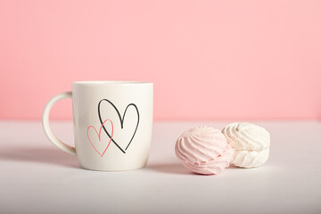 Mug with hearts and sweets on a pink background. Valentine's Day concept. Banner
