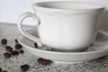 cup of coffee on the table with beans