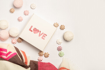 Gift box, beautiful scarf, meringues and sweets on a light background. Composition Valentine's Day. Banner. Flat lay, top view