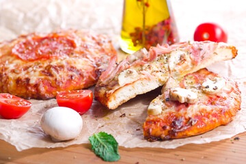 Pizza with mushrooms and ham, cut in half. Half the pizza