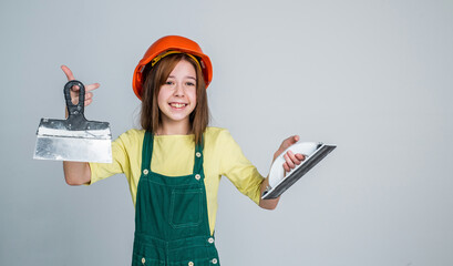girl kid in hard hat on construction site use spatula, equipment
