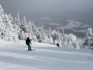 Fototapeta na wymiar View to ski slopes with lot of fresh powder snow at Stowe Mountain resort VT in early December