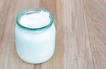 Obraz na płótnie Canvas A jar of natural sour cream with many health benefits