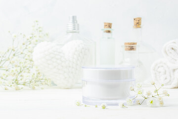 Obraz na płótnie Canvas A jar of cream on the background of spa items. Cosmetics.