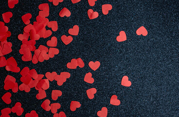 many red hearts on black glitter background, valentine's day