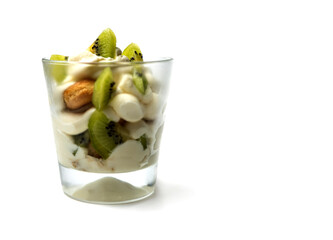 tiramisu in a transparent glass with kiwi on a white background