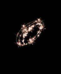the letter o made from sparks of Bengal lights isolated on a black background.