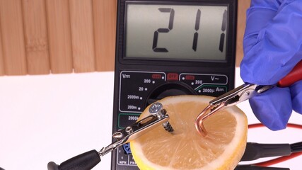 Measuring Electrical Potential of Lemon Using Digital Multimeter Close Up

