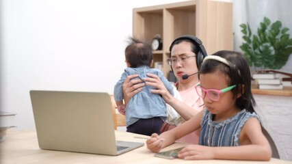 Young woman working by using laptop for business meeting while take care infant during daughter doing homework - Powered by Adobe