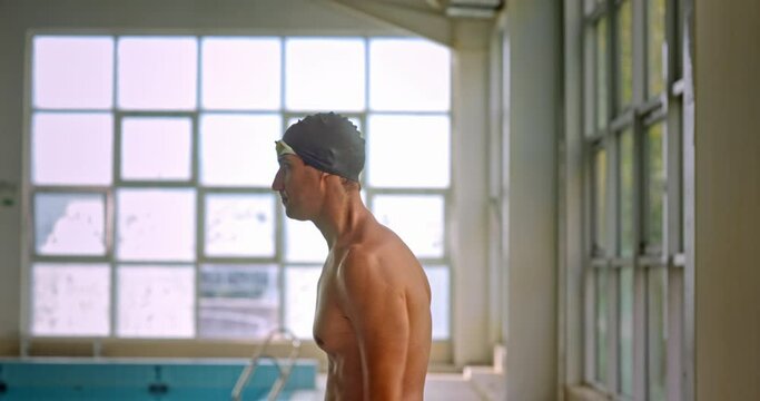 Arms warm up of athlete swimmer amputee in indoor pool