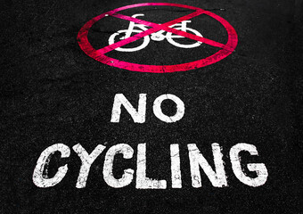 No cycling allowed sign on the ground.