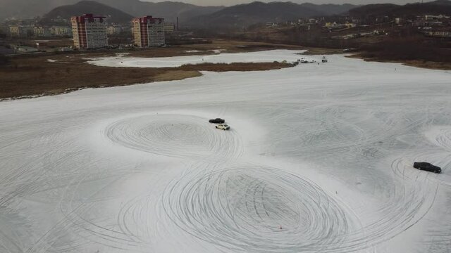Parallel cars drift on ice in a city of Nakhodka in Russia