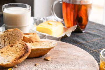 Bread and butter for homemade breakfast with coffee tea milk and organic slide whole wheat rye grain flour brown French  baguette with bio marmalade jam mix with orange passion fruit apricot