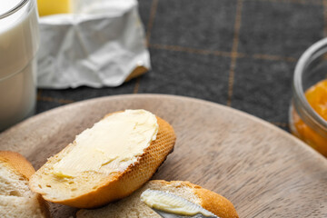 Bread and butter for homemade breakfast with coffee tea milk and organic slide whole wheat rye grain flour brown French  baguette with bio marmalade jam mix with orange passion fruit apricot