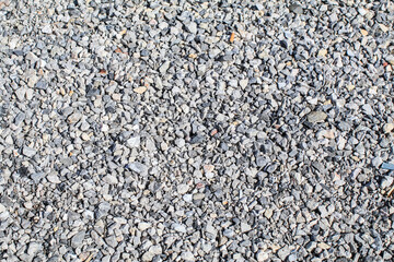 Abstract white crushed stones texture background. Gray rubble construction rock pebble pattern. top view.