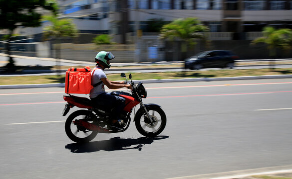 salvador, bahia, brazil - january 6, 2021: food delivery man by application is seen riding a motorcycle on the street in the Pituba neighborhood in the city of Salvador.