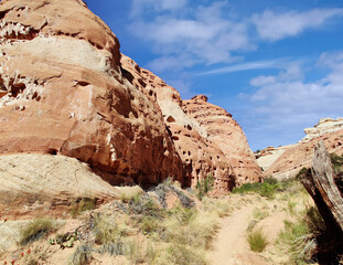 Golden sandstone geographical formations with a desert prairie landscape on a hot summer day at the Cohan Canyon Trail in Capitol Reef National Park Southern Utah.