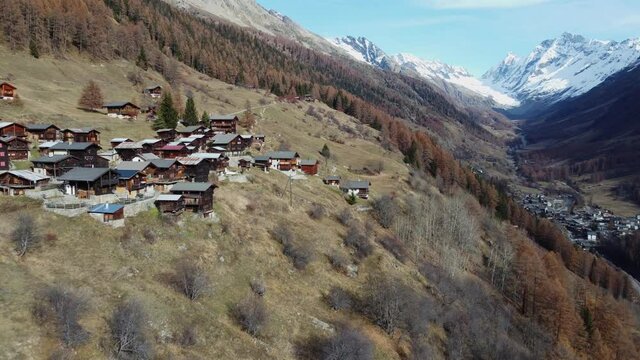 Small village in the L&ouml;tschental in autumn. There are many small huts and a chapel in the village. It is autumn and winter is coming soon. The village Blatten near L&ouml;tschen is in the background