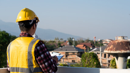 An engineer examining the building with the back view