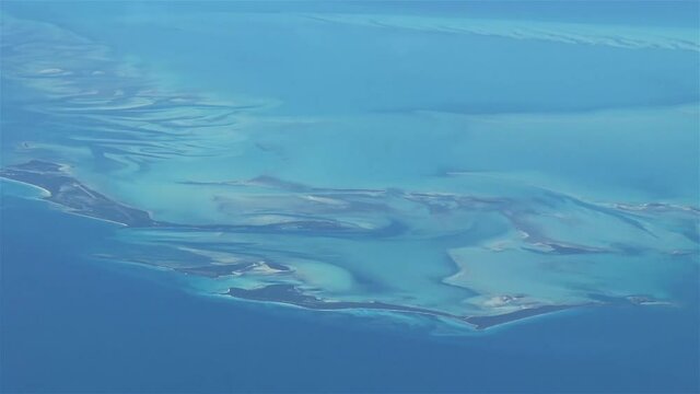 Flying over The Bahamas. Beautiful ocean colors. Actual aerial footage.
