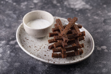 Delicious dark croutonsserved with aromatic garlic sauce. Photo for menu