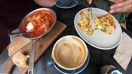 Timelapse of people eating Shakshouka, a latte and the Angelita special at a hipster breakfast cafe in Sydney Australia. 