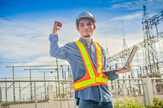 Electrical engineer hold computer notebook at high volte station