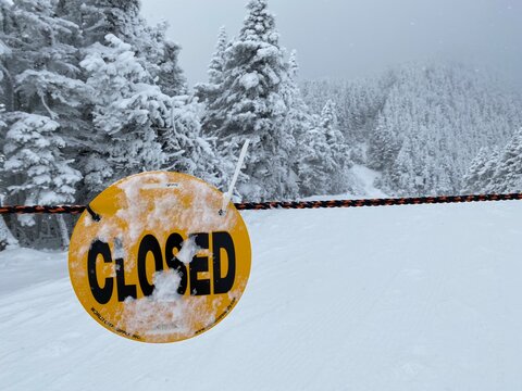 Trail is closed sign at winter snow day at ski resort, VT