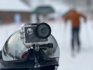 Action camera and ski goggles on the top of the ski helmet. shallow DOF