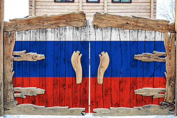 Fototapeta na wymiar Close-up of the national flag of Russia. on a wooden gate at the entrance to the closed territory. The concept of storage of goods, entry to a closed area.