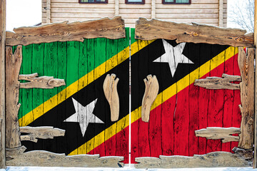 Close-up of the national flag of Saint Kitts and Nevis on a wooden gate at the entrance to the...
