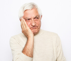 lifestyle, health and old people concept: Portrait of an old man having a toothache against white...