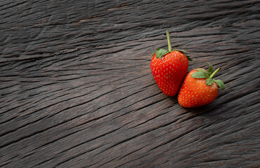 A couple of berries on a wooden background.