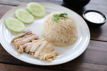 Thai food gourmet steamed chicken with rice khao mun kai in wood background