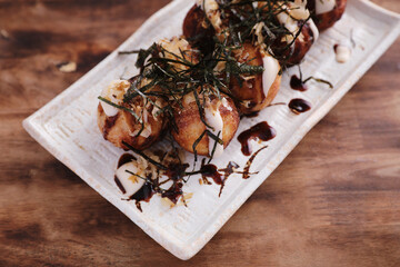 Takoyaki isolated in wood background Japanese food