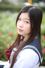 school girl costume at park outdoor with flowers garden background