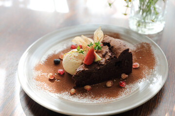 Chocolate cake with ice cream dessert on wood table
