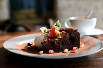 Chocolate cake with ice cream and coffee dessert on wood table